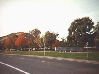[Image of a road, with the UHS campus and the Ukiah High School sign behind it]